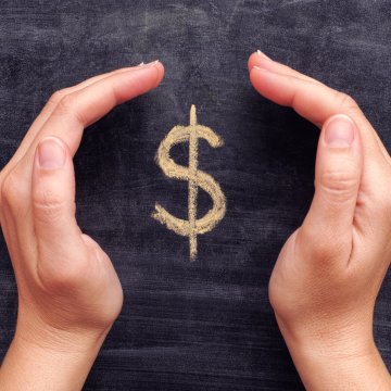 registry cleaner software regclean pro price cost hands holding dollar sign written on blackboard